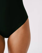 Black One Piece swimsuit worn by a person on a white background