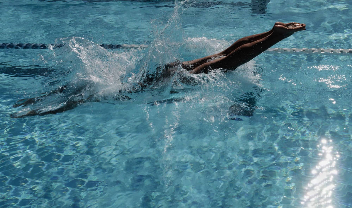 Diving into the pool in the BoucneDown One Piece