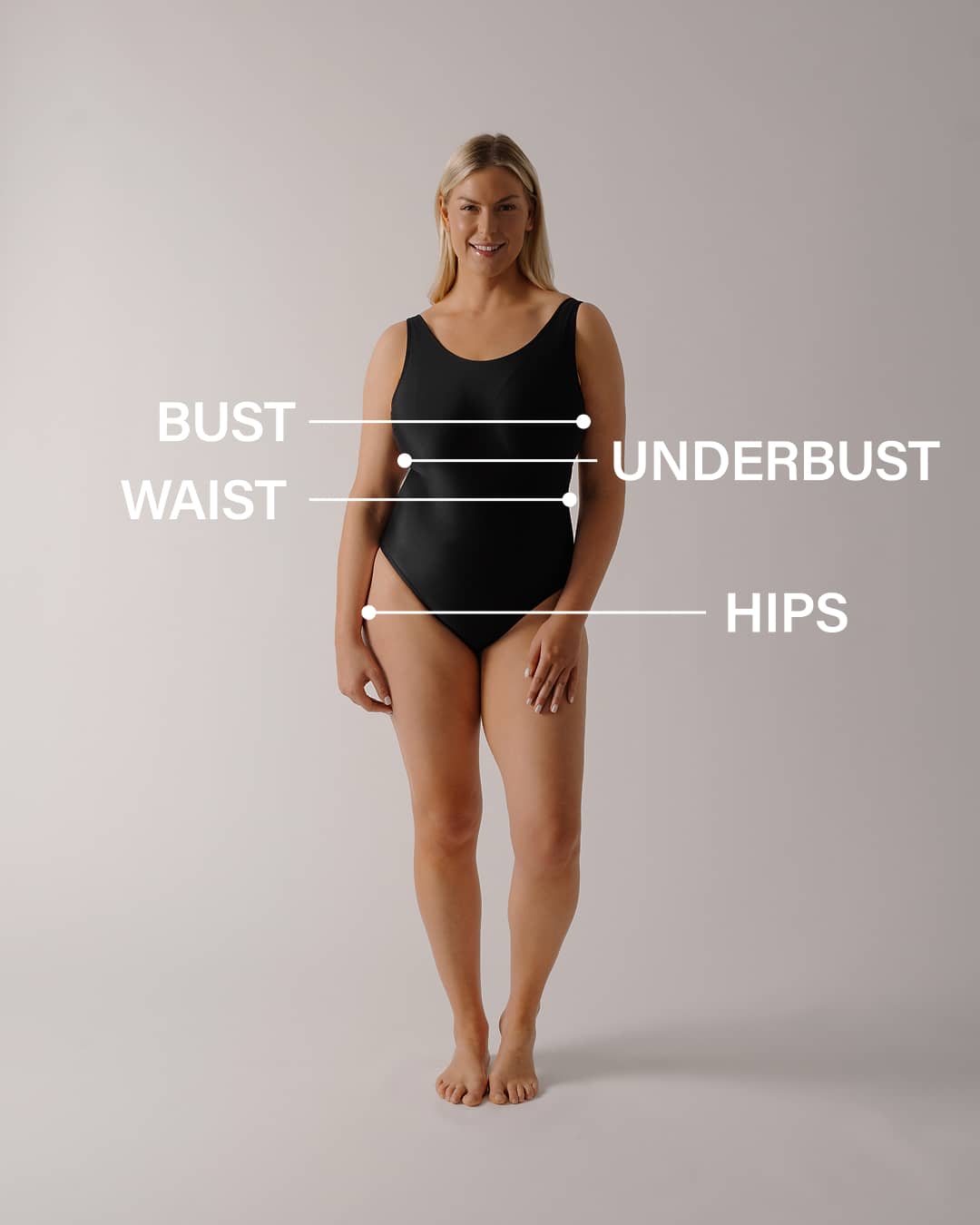 Woman wearing a bouncedown one piece  with labeled measurements on a gray background